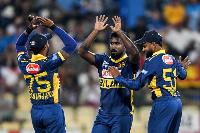 Sri Lanka's Asitha Fernando (C) celebrates with teammates after taking the wicket of England's Zak Crawley during the first one-day international (ODI) cricket match between Sri Lanka and England at the R. Premadasa International Cricket Stadium in Colombo on January 22, 2026. (Photo by Ishara S. KODIKARA / AFP)