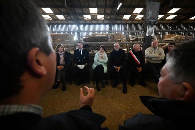 French Minister of Agriculture, Food and Food Sovereignty, Annie Genevard (C), talks with farmers at a farm during a visit concerning aid measures and the emergency agricultural law, in Saint-Georges-de-la-Riviere, northern France, on January 22, 2026. (Photo by Lou BENOIST / AFP)
