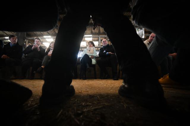 French Minister of Agriculture, Food and Food Sovereignty, Annie Genevard (C), talks with farmers at a farm during a visit concerning aid measures and the emergency agricultural law, in Saint-Georges-de-la-Riviere, northern France, on January 22, 2026. (Photo by Lou BENOIST / AFP)