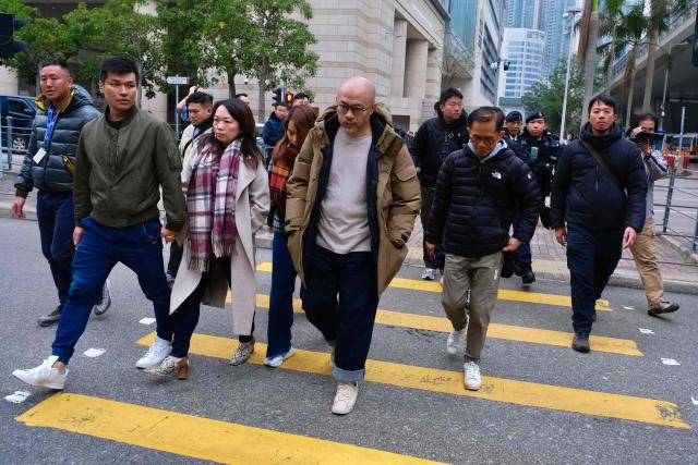 Relatives of Lamma IV ferry disaster victims leave Hong Kong's West Kowloon Law Courts Building after the city's coroner delivered the verdict on the accident, which killed 39 in total in 2012, on January 22, 2026. Family members of those killed in a Hong Kong ferry collision were "outraged" by a long-awaited coroner's verdict, saying on January 22, it offered little by way of accountability or closure. (Photo by Tommy WANG / AFP)
