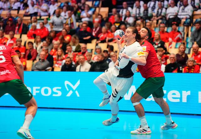 Germany's centre back #15 Juri Knorr (C) vies for the ball during the men's EHF Euro 2026 main round handball match Germany vs Portugal in Herning, Denmark, on January 22, 2026. (Photo by Sebastian Elias Uth / Ritzau Scanpix / AFP) / Denmark OUT
