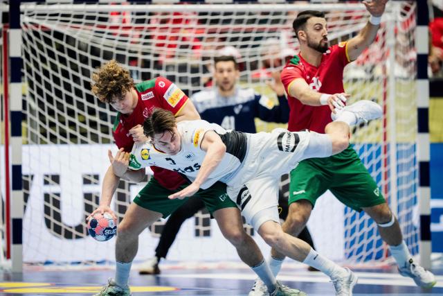 Portugal's centre back #95 Gabriel Oliveira Cavalcanti and Portugal's left back #20 Miguel Neves vie with Germany's left back #05 Miro Schluroff during the men's EHF Euro 2026 main round handball match Germany vs Portugal in Herning, Denmark, on January 22, 2026. (Photo by Sebastian Elias Uth / Ritzau Scanpix / AFP) / Denmark OUT