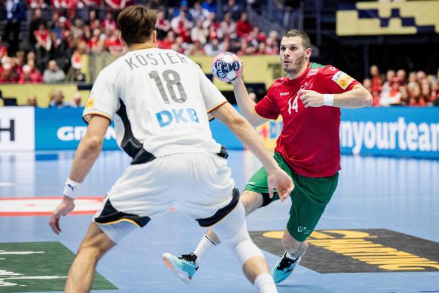 Germany's left back #18 Julian Koester and Portugal's centre back #14 Rui Silva vie for the ball during the men's EHF Euro 2026 main round handball match Germany vs Portugal in Herning, Denmark, on January 22, 2026. (Photo by Sebastian Elias Uth / Ritzau Scanpix / AFP) / Denmark OUT