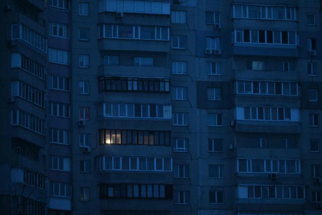 This photograph shows residential buildings during a power outage in Kyiv on January 22, 2026, amid the Russian invasion of Ukraine. (Photo by Sergei GAPON / AFP)