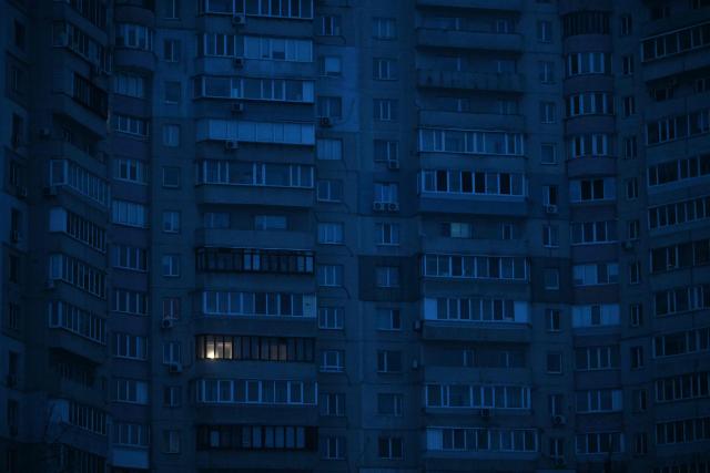 This photograph shows residential buildings during a power outage in Kyiv on January 22, 2026, amid the Russian invasion of Ukraine. (Photo by Sergei GAPON / AFP)