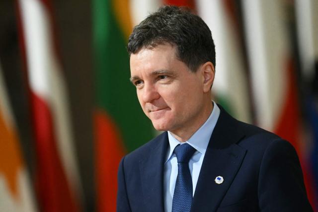 Romania's President Nicusor Dan arrives for a European Council meeting to discuss recent developments in transatlantic relations, in Brussels, on January 22, 2026. EU leaders meet on January 22, 2026, for an emergency summit on threats by US President to impose tariffs on countries opposed to his push to take Greenland, with crisis talks in Brussels coming to weigh potential countermeasures against the United States. (Photo by NICOLAS TUCAT / AFP)