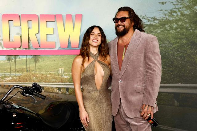 US actor Jason Momoa poses with his partner US actor Adria Arjona on the red carpet upon arrival to attend the UK special screening of the action comedy The Wrecking Crew, in central London on January 22, 2026. (Photo by Brook Mitchell / AFP)