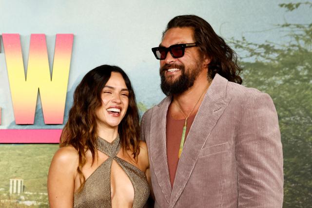 US actor Jason Momoa smiles with his partner US actor Adria Arjona on the red carpet upon arrival to attend the UK special screening of the action comedy The Wrecking Crew, in central London on January 22, 2026. (Photo by Brook Mitchell / AFP)