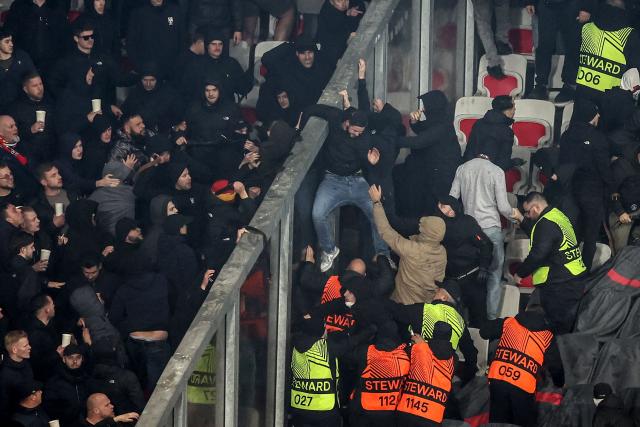 Go Ahead Eagles' supporters (L) and Nice's supporters (R) scuffle during the Europa League football match between OGC Nice and Go Ahead Eagles at Allianz Riviera stadium in Nice on January 22, 2026. (Photo by Valery HACHE / AFP)