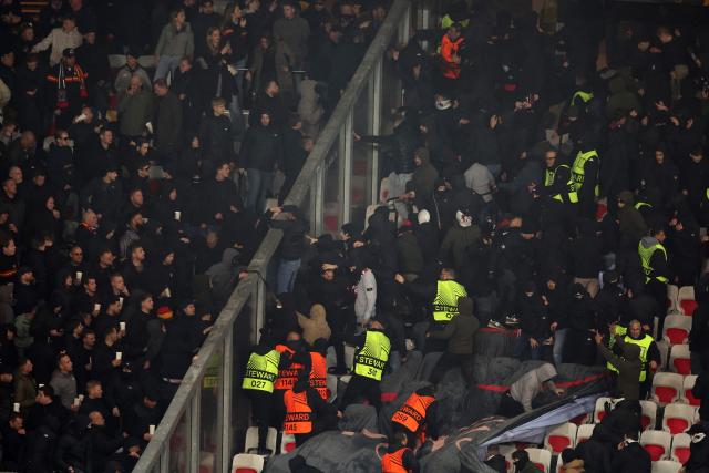 Go Ahead Eagles' supporters (L) and Nice's supporters (R) scuffle during the Europa League football match between OGC Nice and Go Ahead Eagles at Allianz Riviera stadium in Nice on January 22, 2026. (Photo by Valery HACHE / AFP)