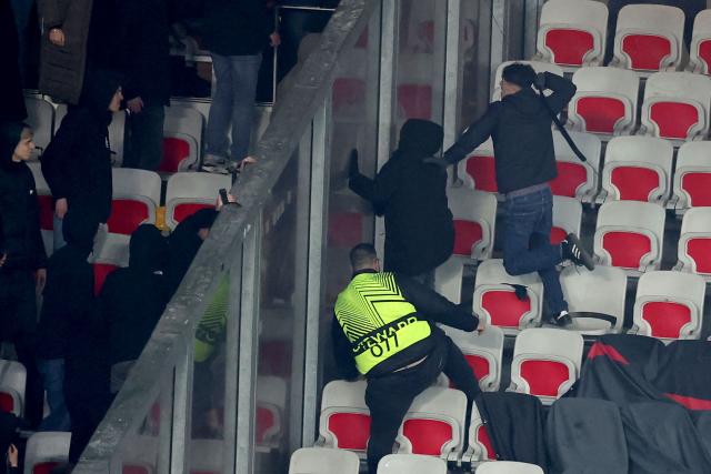 Go Ahead Eagles' supporters (L) and Nice's supporters (R) scuffle during the Europa League football match between OGC Nice and Go Ahead Eagles at Allianz Riviera stadium in Nice on January 22, 2026. (Photo by Valery HACHE / AFP)