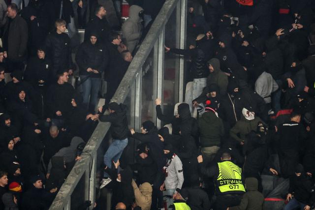 Go Ahead Eagles' supporters (L) and Nice's supporters (R) scuffle during the Europa League football match between OGC Nice and Go Ahead Eagles at Allianz Riviera stadium in Nice on January 22, 2026. (Photo by Valery HACHE / AFP)
