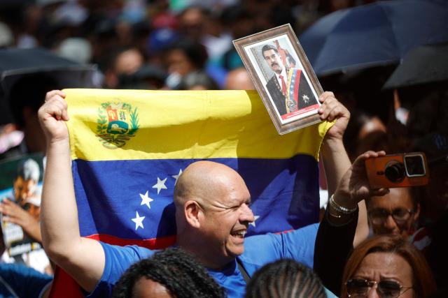 Supporters of ousted Venezuelan President Nicolas Maduro, including health sector workers, take part in a demonstration to the UN headquarters in Caracas to demand his release, on January 22, 2026. (Photo by Pedro MATTEY / AFP)