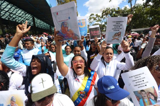 Supporters of ousted Venezuelan President Nicolas Maduro, including health sector workers, take part in a demonstration to the UN headquarters in Caracas to demand his release, on January 22, 2026. (Photo by Pedro MATTEY / AFP)