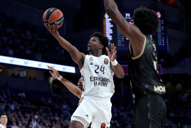TOPSHOT - Real Madrid's Dominican guard #24 Andres Feliz attempts a shot in spite of AS Monaco's US centre #13 Kevarrius Hayes during the Euroleague basketball match between Real Madrid Baloncesto and Monaco at Movistar Arena in Madrid on January 22, 2026. (Photo by Thomas COEX / AFP)