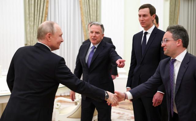 In this pool photograph distributed by the Russian state agency Sputnik, Russia's President Vladimir Putin welcomes US special envoy Steve Witkoff, US President Donald Trump's son-in-law Jared Kushner and Commissioner of the Federal Acquisition Service, FAS, Josh Gruenbaum during a meeting at the Kremlin in Moscow on January 22, 2026. (Photo by Alexander KAZAKOV / POOL / AFP)