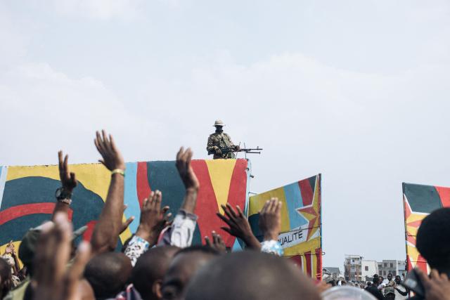 (FILES) Residents raise their hands as an M23 soldier controls from a wall the access to the Stade de l'Unite'(Unity Stadium) in Goma on February 6, 2025 ahead of a public gathering called by the armed group. A year after the M23 armed group seized Goma, residents of the major city in eastern DRC are living in a "catastrophic" situation, according to the Congolese government spokesperson.
On January 26, 2025, a million residents were sheltering in their homes when the Congolese army and its allies abandoned the capital of North Kivu province. Hundreds of Rwandan soldiers, allied with the anti-government armed group M23, had just crossed the border and entered the lakeside city, at the cost of intense fighting that left thousands dead.
Felix Tshisekedi, his successor as the DRC's president, accuses Kabila of being the brains behind the armed group. (Photo by Alexis Huguet / AFP)