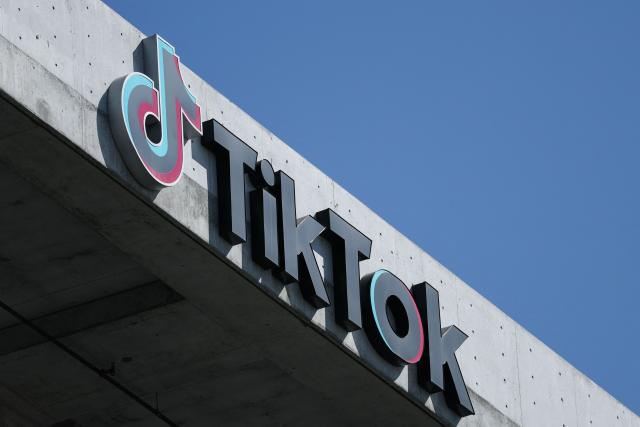 (FILES) The TikTok logo is displayed on signage outside TikTok social media app company offices in Culver City, California on September 30, 2025. TikTok announced on January 22, 2026 that it has established a majority American-owned joint venture to operate its US business that will allow the company to avoid a ban over its Chinese ownership. The TikTok USDS Joint Venture LLC will serve more than 200 million users and 7.5 million businesses while implementing strict safeguards for data protection, algorithm security and content moderation, the company said. (Photo by Patrick T. Fallon / AFP)