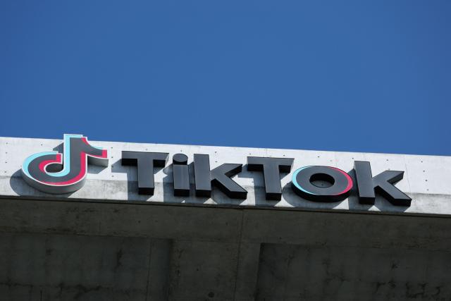 (FILES) The TikTok logo is displayed on signage outside TikTok social media app company offices in Culver City, California on September 30, 2025. TikTok announced on January 22, 2026 that it has established a majority American-owned joint venture to operate its US business that will allow the company to avoid a ban over its Chinese ownership. The TikTok USDS Joint Venture LLC will serve more than 200 million users and 7.5 million businesses while implementing strict safeguards for data protection, algorithm security and content moderation, the company said. (Photo by Patrick T. Fallon / AFP)