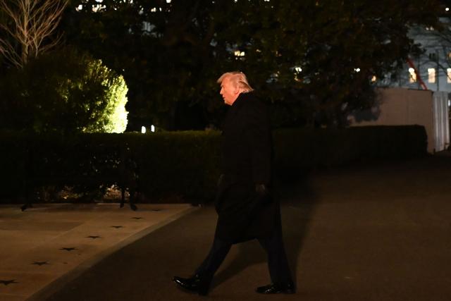 US President Donald Trump walks from the South Lawn upon arrival at the White House in Washington, DC, on January 22, 2026. Trump returned from the World Economic Forum (WEF) in Davos, Switzerland where he backed down on threats to seize Greenland by force from ally Denmark, announcing a vague deal aimed at ensuring security of the Arctic territory on January 21, 2026. (Photo by Alex WROBLEWSKI / AFP)