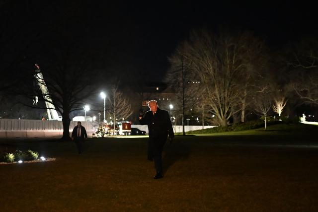 US President Donald Trump raises a fist as he walks from the South Lawn upon arrival at the White House in Washington, DC on January 22, 2026. Trump returned from the World Economic Forum (WEF) in Davos, Switzerland where he backed down on threats to seize Greenland by force from ally Denmark, announcing a vague deal aimed at ensuring security of the Arctic territory on January 21, 2026. (Photo by Alex WROBLEWSKI / AFP)