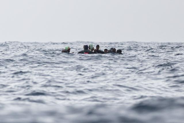 (FILES) Migrants onboard a rubber boat wait to be rescued by crew members of the “Ocean Viking” rescue ship in the search-and-rescue zone off the international waters of Libya, on January 16, 2026. (Photo by Sameer Al-DOUMY / AFP)