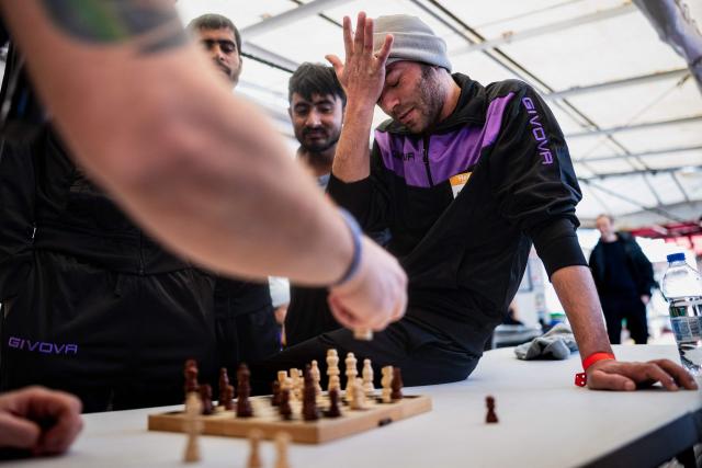 (FILES) An Egyptian migrant reacts as he loses a chess game onboard the rescue ship "Ocean Viking" operated by the NGO SOS Mediterranee, as it sails in the Mediterranean Sea toward the designated port of disembarkation in Palermo, southern Italy, on January 18, 2026. (Photo by Sameer Al-DOUMY / AFP)