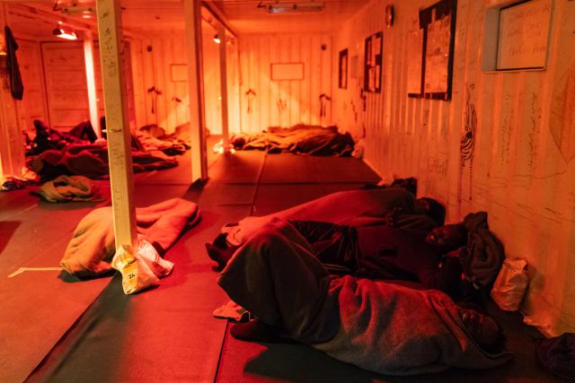 (FILES) Migrants rest at the men's shelter onboard the rescue ship "Ocean Viking" operated by humanitarian NGO SOS Mediterranee, in the Mediterranean Sea near the Italian coast on January 2, 2026. (Photo by Sameer Al-DOUMY / AFP)