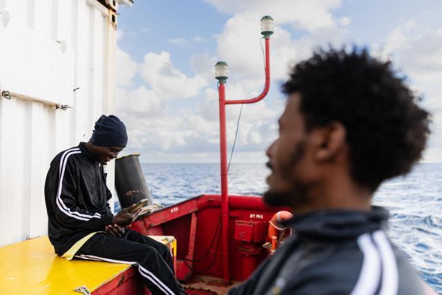 (FILES) A migrant makes a video call onboard the rescue ship "Ocean Viking" operated by the NGO SOS Mediterranee, in the search-and-rescue zone of the international waters near Malta, on January 1, 2026. (Photo by Sameer Al-DOUMY / AFP)