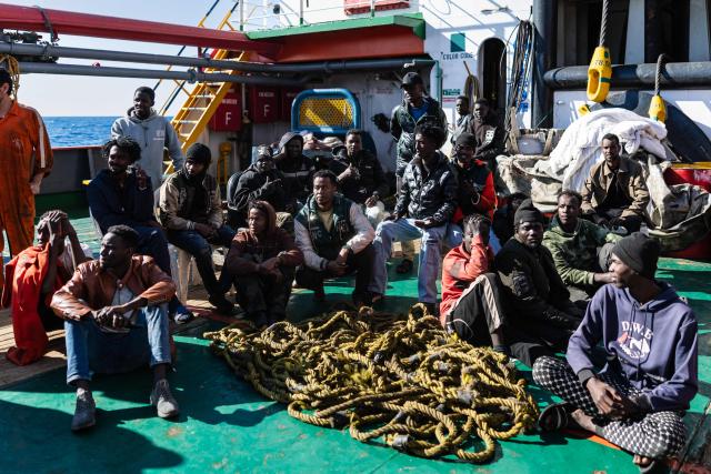 (FILES) Migrants listen to instructions from crew members of the “Ocean Viking” rescue ship as they prepare to board a RHIB (Rigid inflatable boat) from the oil tanker the Maridive 703, in the search-and-rescue zone in international waters between Malta and Tunisia, on December 31, 2025. (Photo by Sameer Al-DOUMY / AFP)