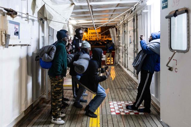 (FILES) Migrants take a group picture as they prepare to disembark from the rescue ship "Ocean Viking" operated by the NGO SOS Mediterranee, at the port of Savona, northwestern Italy, on January 5, 2026. (Photo by Sameer Al-DOUMY / AFP)