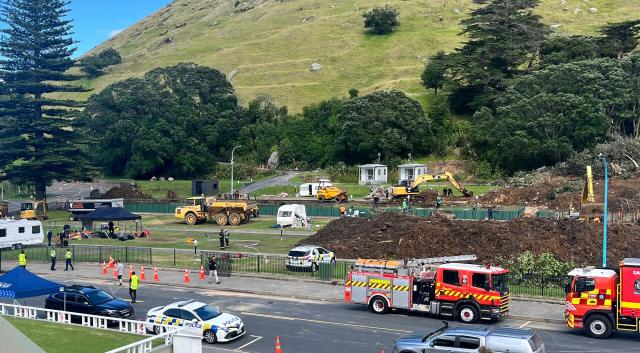 A search continues by local emergency services for missing people following a landslide at Mount Maunganui in Tauranga on January 23, 2026. Rescuers dug into deep mud searching for at least six missing people on January 23, after a landslide from an extinct volcano crashed into a popular campsite in northern New Zealand. (Photo by Ben STRANG / AFP)