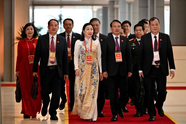 Delegates arrive to attend the closing ceremony of the 14th National Congress of the Communist Party of Vietnam at the National Convention Centre in Hanoi on January 23,2026. (Photo by Nhac NGUYEN / AFP)