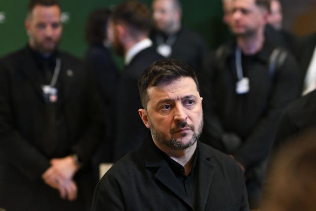 Ukraine's President Volodymyr Zelensky looks on as he attends the World Economic Forum (WEF) annual meeting in Davos on January 22, 2026. The World Economic Forum takes place in Davos from January 19 to January 23, 2026. (Photo by Fabrice COFFRINI / AFP)