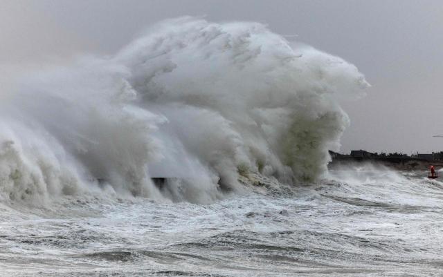Waves crash against the pier at the port of Plobannalec-Lesconil, in western France, on January 23, 2026. Depression Ingrid is expected to bring rain, strong winds and high waves to several departments in Brittany on Friday, where some towns are already flooded and others are preparing for rising water levels. (Photo by Fred TANNEAU / AFP)