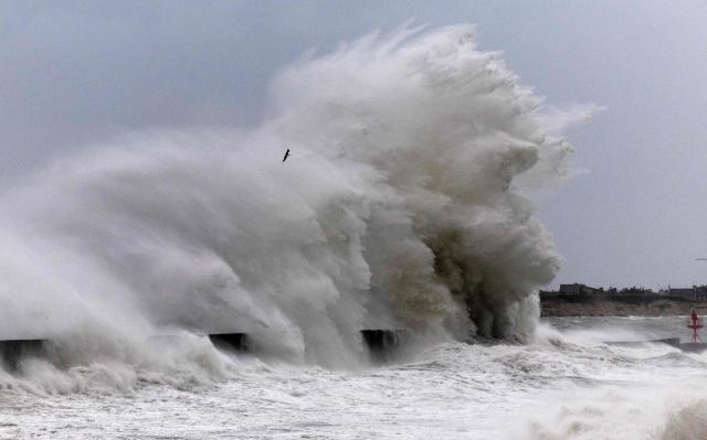 Waves crash against the pier at the port of Plobannalec-Lesconil, in western France, on January 23, 2026. Depression Ingrid is expected to bring rain, strong winds and high waves to several departments in Brittany on Friday, where some towns are already flooded and others are preparing for rising water levels. (Photo by Fred TANNEAU / AFP)