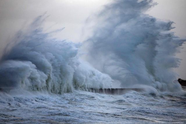Waves crash against the pier at the port of Plobannalec-Lesconil, in western France, on January 23, 2026. Depression Ingrid is expected to bring rain, strong winds and high waves to several departments in Brittany on Friday, where some towns are already flooded and others are preparing for rising water levels. (Photo by Fred TANNEAU / AFP)
