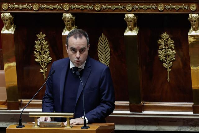 France's Prime Minister Sebastien Lecornu delivers his speech during a debate and ahead a vote on two no-confidence motions against his 49.3 on the "revenue" part of the budget bill for 2026 at the Assemblee Nationale, France's Parliament lower house in Paris on January 23, 2026. Members of Parliament are expected to reject on January 23, 2026 the two motions brought by the left outside the Socialist Party and the far right in response to the 49.3 triggered by France's Prime Minister, allowing him to engage a second 49.3, on the "expenditure" part of the text. (Photo by STEPHANE DE SAKUTIN / AFP)