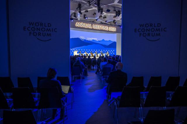 Attendees are seen during a session at the Congress Centre during the final day of the World Economic Forum (WEF) annual meeting in Davos on January 23, 2026. (Photo by Fabrice COFFRINI / AFP)