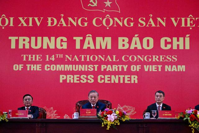 Vietnam's relected Communist Party General Secretary To Lam (C) addresses a press conference after the closing ceremony of the Communist Party of Vietnam's (CPV) 14th National Congress at the National Convention Centre in Hanoi on January 23, 2026. Vietnam's Communist Party "unanimously" re-elected To Lam to the post of general secretary on January 23, it said on its website, confirming he will remain the country's top leader for the next five years. (Photo by Nhac NGUYEN / AFP)