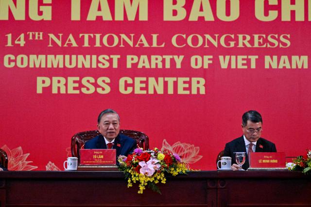 Vietnam's relected Communist Party General Secretary To Lam (L) addresses a press conference after the closing ceremony of the Communist Party of Vietnam's (CPV) 14th National Congress at the National Convention Centre in Hanoi on January 23, 2026. Vietnam's Communist Party "unanimously" re-elected To Lam to the post of general secretary on January 23, it said on its website, confirming he will remain the country's top leader for the next five years. (Photo by Nhac NGUYEN / AFP)