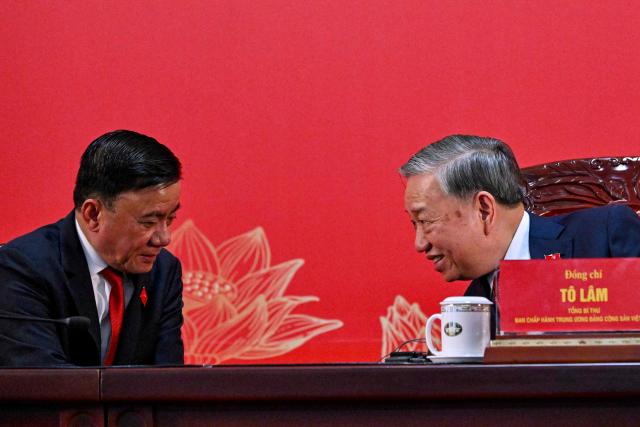 Vietnam's relected Communist Party General Secretary To Lam (R) addresses a press conference after the closing ceremony of the Communist Party of Vietnam's (CPV) 14th National Congress at the National Convention Centre in Hanoi on January 23, 2026. Vietnam's Communist Party "unanimously" re-elected To Lam to the post of general secretary on January 23, it said on its website, confirming he will remain the country's top leader for the next five years. (Photo by Nhac NGUYEN / AFP)