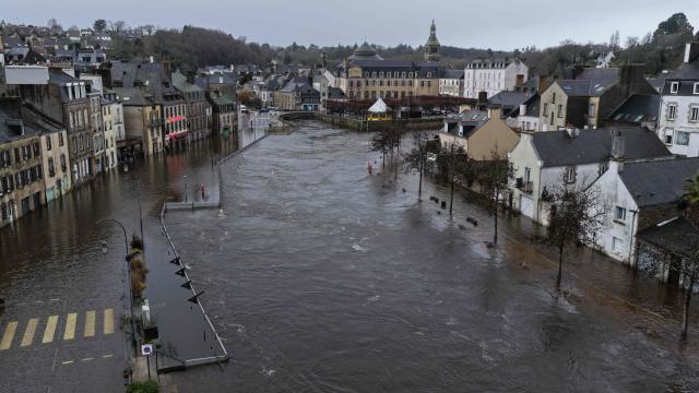 TOPSHOT - This aerial photograph shows the city center flooded by the Laita river in Quimperle, western France on January 23, 2026. (Photo by Damien MEYER / AFP)