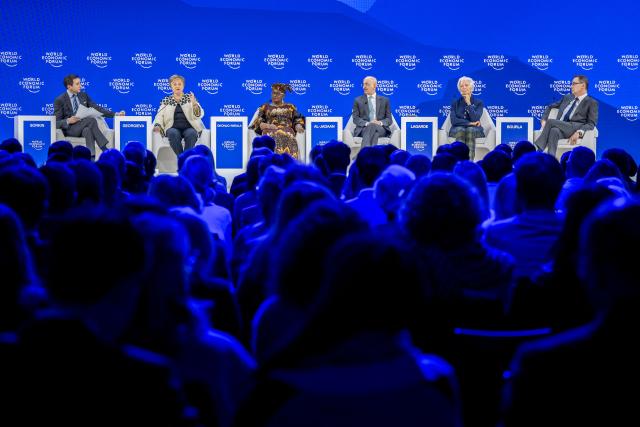 (From L) New York Times' editor-at-large Andrew Sorkin, International Monetary Fund (IMF) managing director Kristalina Georgieva, World Trade Organization (WTO) Director-General Ngozi Okonjo-Iweala, Saudi Arabia's Finance Minister Mohammed Al-Jadaan, European Central Bank (ECB) president Christine Lagarde and Pfizer Chairman and CEO Albert Bourla attend a session during the final day of the World Economic Forum (WEF) annual meeting in Davos on January 23, 2026. (Photo by Fabrice COFFRINI / AFP)
