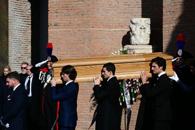 Pallbearers carry the coffin of the late Italian fashion designer Valentino Gavarani after the funeral ceremony at the Basilic of Santa Maria degli Angeli e dei Martiri in Rome on January 23, 2026. (Photo by Stefano RELLANDINI / AFP)