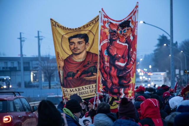 Fans wave banners bearing the picture of British driver Lewis Hamilton and Monaco's driver Charles Leclerc before the test of the new Formula 1 Ferrari SF-26 at Fiorano Circuit in Fiorano Modenese, on January 23, 2026. (Photo by Federico SCOPPA / AFP)