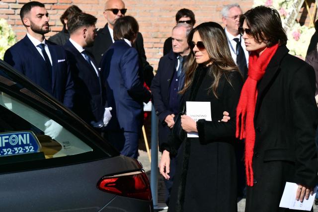 British actress and model Liz Hurley (2nd R) and her son Damian Hurley leave the funeral ceremony for the late Italian fashion designer Valentino Gavarani at the Basilic of Santa Maria degli Angeli e dei Martiri, in Rome on January 23, 2026. (Photo by Stefano RELLANDINI / AFP)