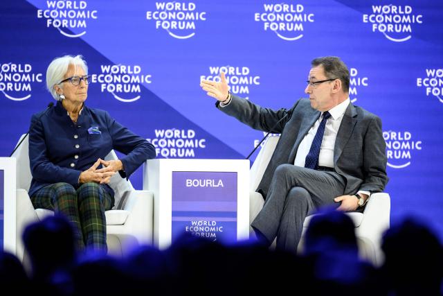 Pfizer Chairman and CEO Albert Bourla (R) gestures next to European Central Bank (ECB) president Christine Lagarde during a session during the final day of the World Economic Forum (WEF) annual meeting in Davos on January 23, 2026. (Photo by Fabrice COFFRINI / AFP)