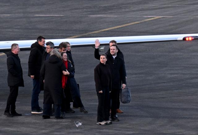 Danish Prime Minister Mette Frederiksen (2nd R) is welcomed by Greenland's Prime Minister Jens-Frederik Nielsen (R) after she landed at the airport in Nuuk, Greenland, on January 23, 2026. Frederiksen will hold talks with her Greenlandic counterpart after a turbulent week that saw US President Donald Trump back down from his threats to seize the Arctic island and agree to talks. Frederiksen travelled to the Greenland capital Nuuk from Brussels, where she held talks earlier with NATO Secretary General Mark Rutte, who reached a purported deal with Trump on Greenland at the World Economic Forum in Davos. (Photo by Jonathan Nackstrand / AFP)
