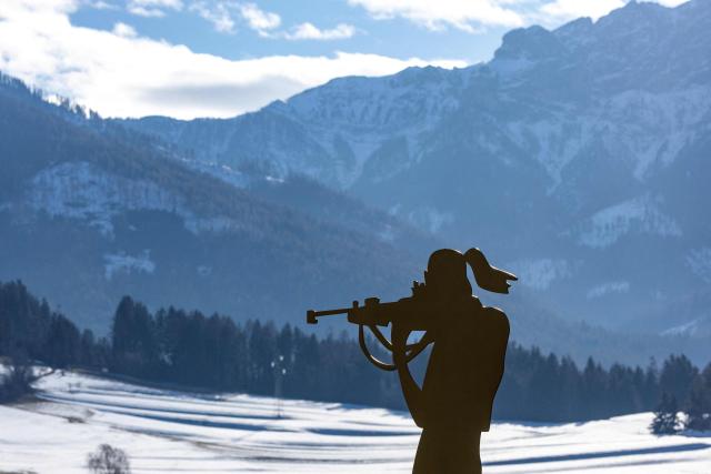 A figurine of a biathlete is seen at the entrance to the village of Antholz, northern Italy, the venue for the Olympic Biathlon competitions of the Milano Cortina 2026 Olympic Games, on January 23, 2026. (Photo by Odd ANDERSEN / AFP)